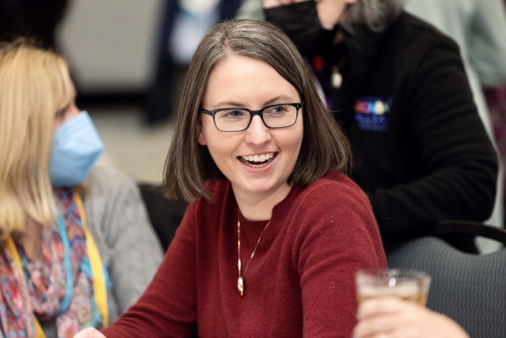Lady with glasses smiling at the American Epilepsy Society annual conference